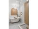 Stylish bathroom boasts a freestanding tub, brass fixtures, and a modern glass enclosed shower with wood look tiling at 1113 Black Acre Trl, Winter Springs, FL 32708