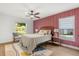 Cozy bedroom with a decorative accent wall, natural light, and stylish furnishings at 1113 Black Acre Trl, Winter Springs, FL 32708