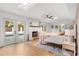Sunlit bedroom featuring a charming fireplace, skylights, and French doors leading to the pool area at 1113 Black Acre Trl, Winter Springs, FL 32708