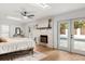 Bright bedroom with a fireplace, skylights, and double doors leading to a pool at 1113 Black Acre Trl, Winter Springs, FL 32708