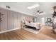 Bright bedroom with skylights, accent wall, and hardwood floors for an open airy space at 1113 Black Acre Trl, Winter Springs, FL 32708