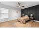 Cozy bedroom featuring hardwood floors, modern fan, and decorative wall art at 1113 Black Acre Trl, Winter Springs, FL 32708