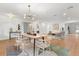 Open dining area featuring a stylish table, modern chandelier, and views into the adjacent living area at 1113 Black Acre Trl, Winter Springs, FL 32708