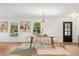 Bright dining area featuring modern chandelier, wood table, and natural light from nearby windows at 1113 Black Acre Trl, Winter Springs, FL 32708