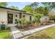 Inviting front entrance with stone walkway and lush landscaping leading to the front door at 1113 Black Acre Trl, Winter Springs, FL 32708