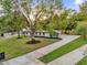 Aerial view of property showcasing mature trees, long driveway, and lush green lawn at 1113 Black Acre Trl, Winter Springs, FL 32708