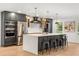 Bright kitchen featuring stainless steel appliances, a spacious island, and modern cabinetry at 1113 Black Acre Trl, Winter Springs, FL 32708