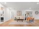 Comfortable living room showcasing neutral walls, wood floors, modern furniture, and an open doorway at 1113 Black Acre Trl, Winter Springs, FL 32708