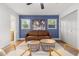 Comfortable living room features a vintage leather sofa and hardwood floors at 1113 Black Acre Trl, Winter Springs, FL 32708