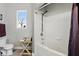Functional bathroom with a tub-shower combination, white tiling, and a window providing natural light at 114 Vista Verdi Cir # 136, Lake Mary, FL 32746