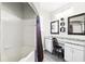 Bright bathroom features double sinks, granite counters, a combination shower-tub, and stylish mirrors at 114 Vista Verdi Cir # 136, Lake Mary, FL 32746