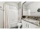Bright bathroom features white tile, granite countertops, and a shower-tub combination, offering a fresh space at 114 Vista Verdi Cir # 136, Lake Mary, FL 32746
