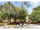Apartment building with lush greenery and trees, offering a peaceful living environment for its residents at 114 Vista Verdi Cir # 136, Lake Mary, FL 32746