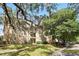 Three-story apartment building with tan exterior and mature trees creating a serene environment at 114 Vista Verdi Cir # 136, Lake Mary, FL 32746