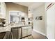 Open concept kitchen features granite counters, stainless appliances, and a view into an adjacent room at 114 Vista Verdi Cir # 136, Lake Mary, FL 32746