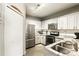 Bright kitchen with stainless steel appliances, granite countertops and white cabinets offers style and function at 114 Vista Verdi Cir # 136, Lake Mary, FL 32746