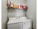 Practical laundry area features a washer, dryer, and shelving for storage, simplifying chores at 114 Vista Verdi Cir # 136, Lake Mary, FL 32746