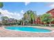 Community pool surrounded by lush landscaping and comfortable lounge chairs, perfect for relaxation at 114 Vista Verdi Cir # 136, Lake Mary, FL 32746