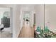 Hallway with access to the living room and main bedroom, with natural light and hardwood floors at 1196 Alstonia Ln, Mount Dora, FL 32757