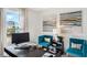 Home office with work station, blue chairs, and natural light at 1196 Alstonia Ln, Mount Dora, FL 32757