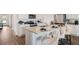Modern kitchen with a large island, stainless steel appliances, and stylish white cabinetry at 1196 Alstonia Ln, Mount Dora, FL 32757