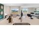 Open-concept dining and living area with hardwood floors and natural light at 1196 Alstonia Ln, Mount Dora, FL 32757