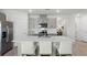 Contemporary kitchen featuring a spacious island with seating, modern appliances, and elegant gray cabinetry at 1200 Alstonia Ln, Mount Dora, FL 32757