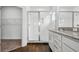 Bathroom featuring glass shower with a marble surround, dark hardwood floors, granite vanity and stainless fixtures at 14259 Kellogg Ave, Orlando, FL 32827