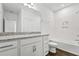 Bathroom featuring granite countertops, white cabinets, and a shower-tub combo at 14259 Kellogg Ave, Orlando, FL 32827