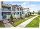 Charming townhome with a landscaped front yard and a view of the community park at 14259 Kellogg Ave, Orlando, FL 32827