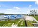 Lake view of an inflatable water park, sandy beach, and an obstacle climbing structure at 14259 Kellogg Ave, Orlando, FL 32827