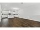 A living area with white walls and modern kitchen with white cabinetry at 14259 Kellogg Ave, Orlando, FL 32827