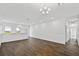 A spacious living area featuring wood floors and bright, neutral walls at 14259 Kellogg Ave, Orlando, FL 32827