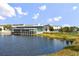 Exterior view of restaurant located on a lake with floor-to-ceiling windows and ample outdoor seating at 14259 Kellogg Ave, Orlando, FL 32827