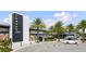 Exterior view of a restaurant with bright geometric art and landscaping with tropical palm trees at 14259 Kellogg Ave, Orlando, FL 32827