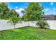 Backyard featuring a healthy lawn, white vinyl fence, and green trees in a beautiful fenced yard at 1585 Maidencane Loop, Oviedo, FL 32765
