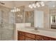 Bathroom featuring a glass-enclosed shower, white vanity and large mirrors with good lighting at 1585 Maidencane Loop, Oviedo, FL 32765