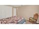 A cozy bedroom with a bed, rocking chair, carpet, and neutral-colored walls at 1585 Maidencane Loop, Oviedo, FL 32765
