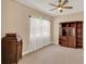 Comfortable den with neutral walls, plush carpeting, and a large window with sheer curtains at 1585 Maidencane Loop, Oviedo, FL 32765