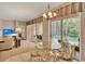 Cozy dining area with table, chandelier and sliding glass doors to the pool and lanai at 1585 Maidencane Loop, Oviedo, FL 32765