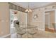 Charming dining area with decorative table, chandelier and view of screened patio at 1585 Maidencane Loop, Oviedo, FL 32765
