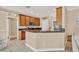 Well-maintained kitchen featuring wood cabinets, granite countertops, and modern appliances at 1585 Maidencane Loop, Oviedo, FL 32765