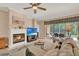 Cozy living room featuring a fireplace, TV, and a comfortable sectional sofa overlooking the screened-in patio at 1585 Maidencane Loop, Oviedo, FL 32765