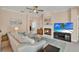 Comfortable living room with a fireplace, TV, and a view into the home's interior at 1585 Maidencane Loop, Oviedo, FL 32765