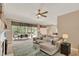 Bright living room with a comfortable sectional sofa, ceiling fan, and a screened-in patio view at 1585 Maidencane Loop, Oviedo, FL 32765