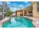 Sparkling pool and spa in a screened enclosure with covered patio and lounge area at 1585 Maidencane Loop, Oviedo, FL 32765