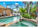 Screened pool with mature landscaping and an attached spa offer a relaxing backyard oasis at 1585 Maidencane Loop, Oviedo, FL 32765