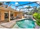 Screened-in pool with outdoor seating area is ideal for entertaining or enjoying peaceful moments at 1585 Maidencane Loop, Oviedo, FL 32765