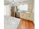 Bright kitchen featuring stainless steel appliances, granite countertops, and wooden floors at 1603 Gaston Foster Rd, Orlando, FL 32812