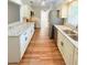 Kitchen with white cabinetry, stainless steel appliances, and long granite countertops at 1603 Gaston Foster Rd, Orlando, FL 32812